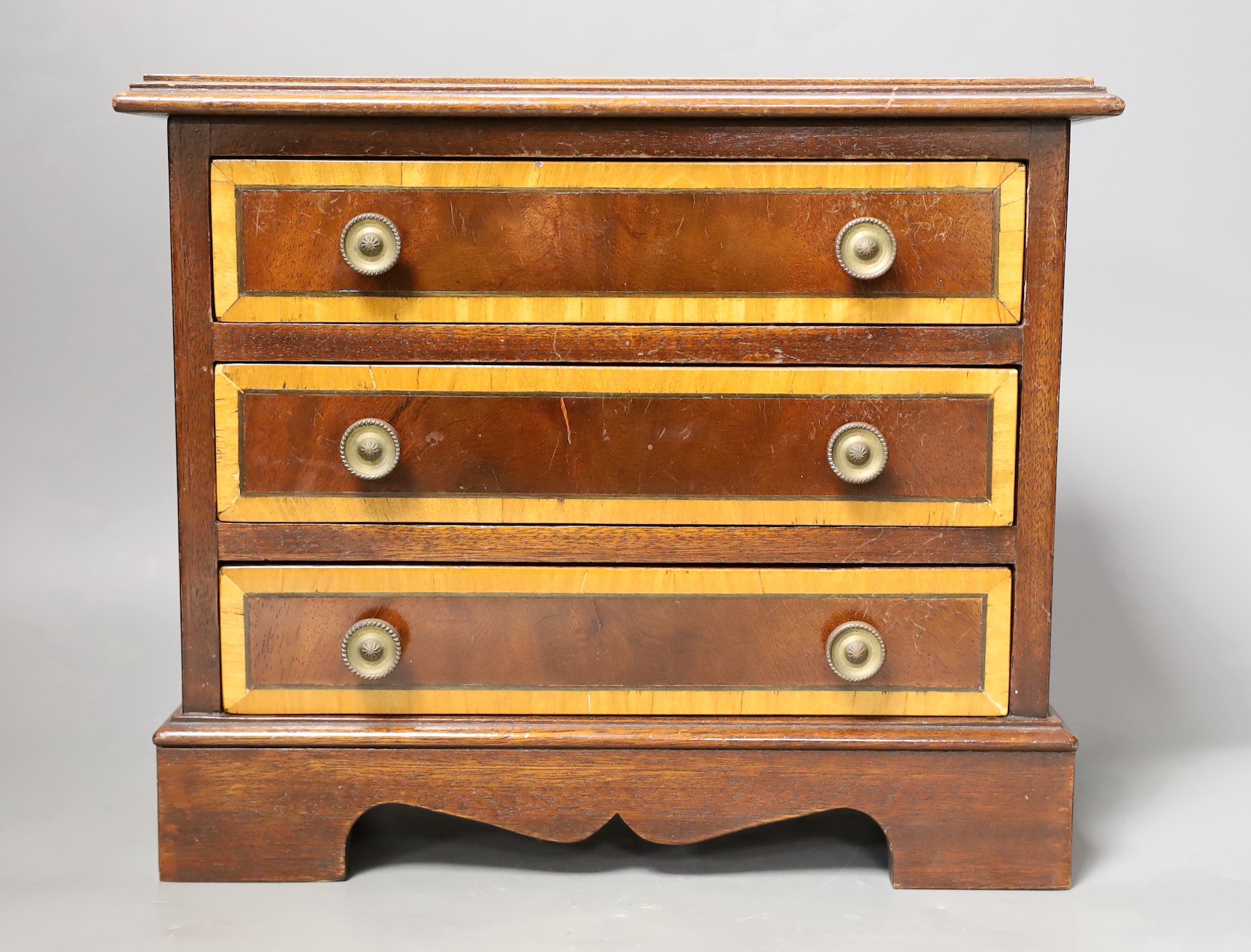 A miniature inlaid mahogany chest, 29cms wide x 25.5 cms high